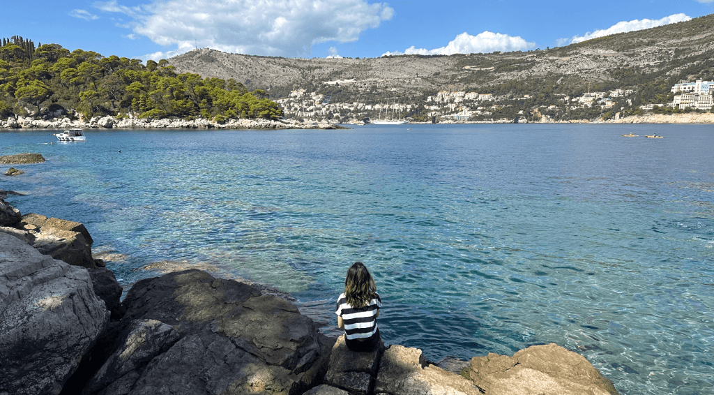Girl sitting on rock on Lokrum Island