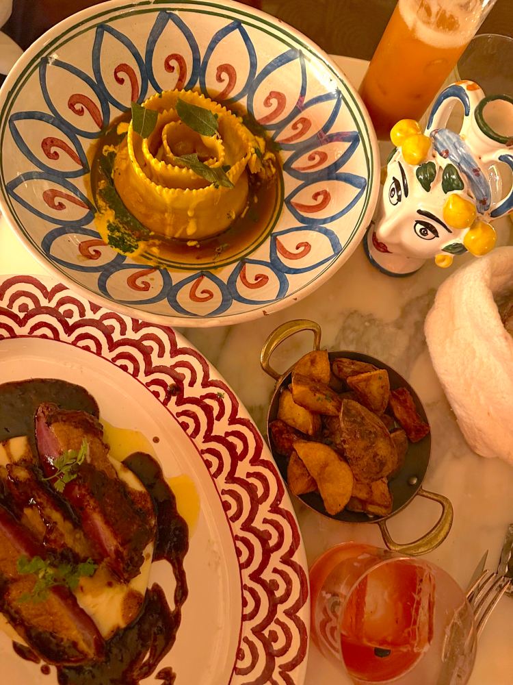 Pasta in spiral shape, duck, and side of potatoes