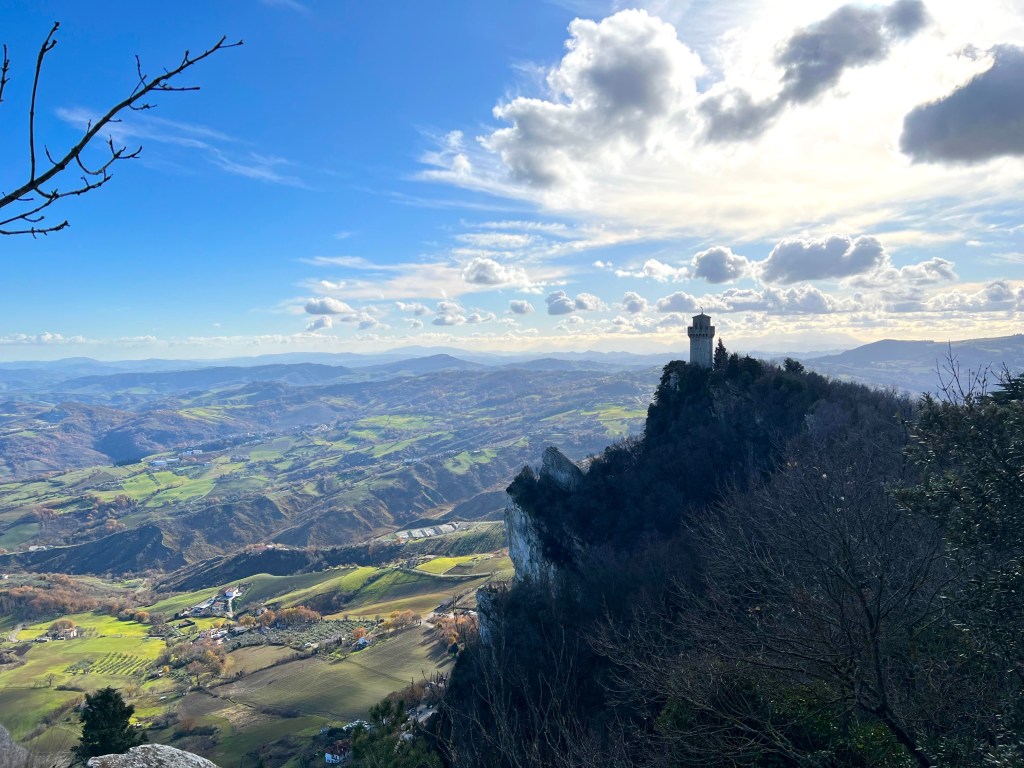 Tower on hill with green farm land below