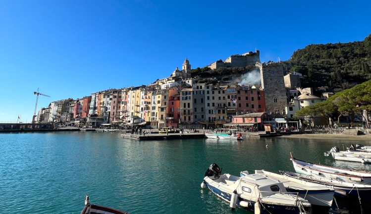 Harbor view of colorful houses with small boats on the water