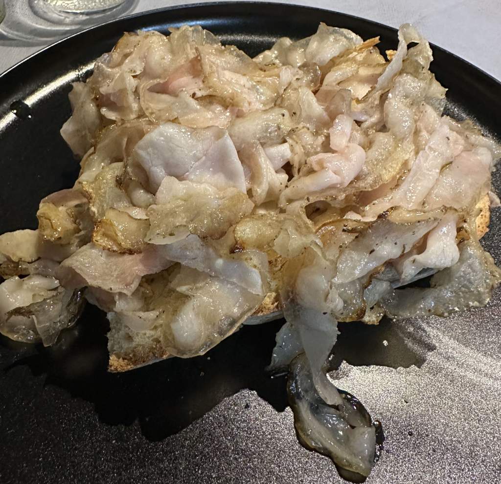 Thin slices of pork on top of bread