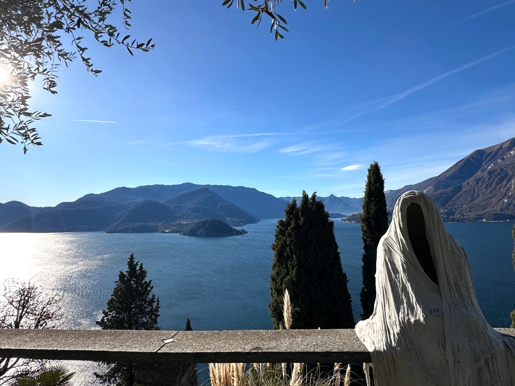 Ghost statue perched with Lake Como in background