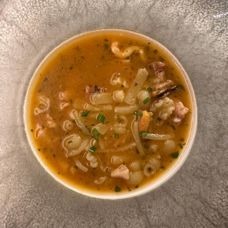 Pasta in soup with seafood