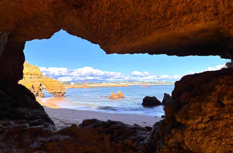 Carved shaped opening with ocean and beach in the background