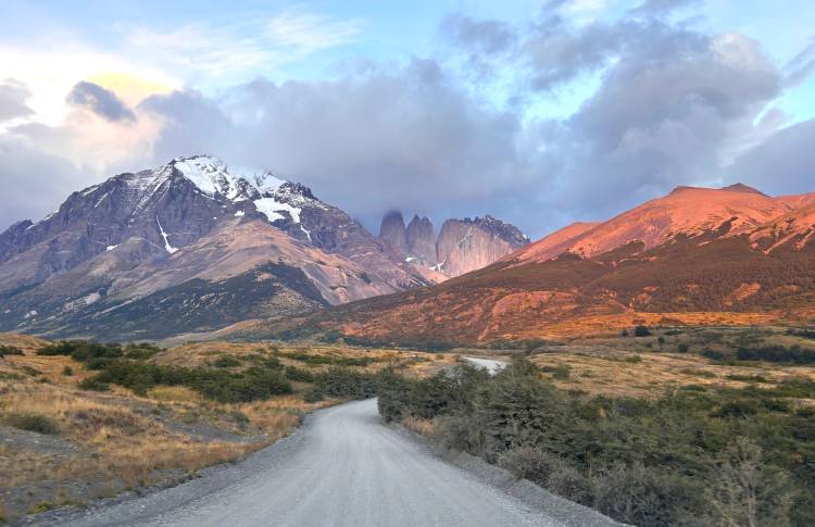 Driving road with Torres del Paine mountains at sunrise