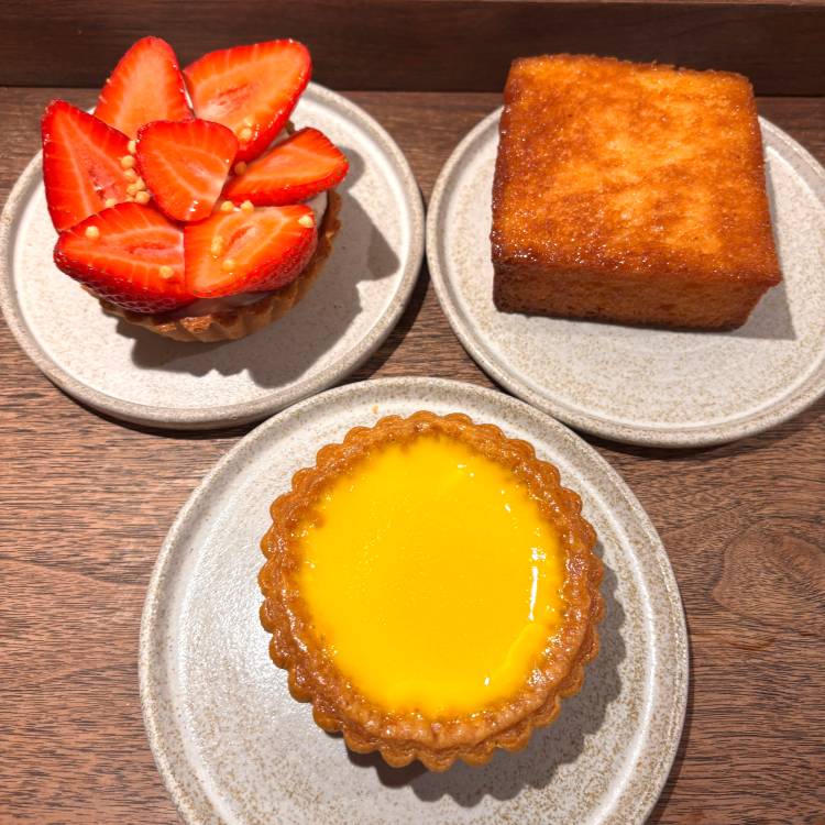 From top left clockwise: strawberry tart, honey french toast, and egg tart at Arôme Bakery