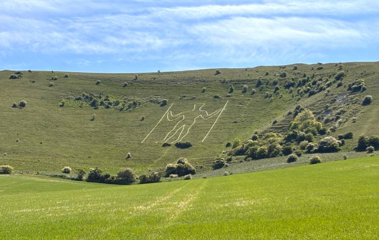 Carving in a hillside of a man holding two poles