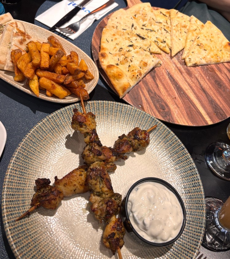 Chicken souvlaki, focaccia, and side of pita and fries at Opa