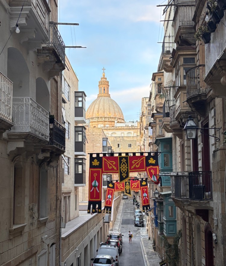 Valletta streets with dome building in backdrop
