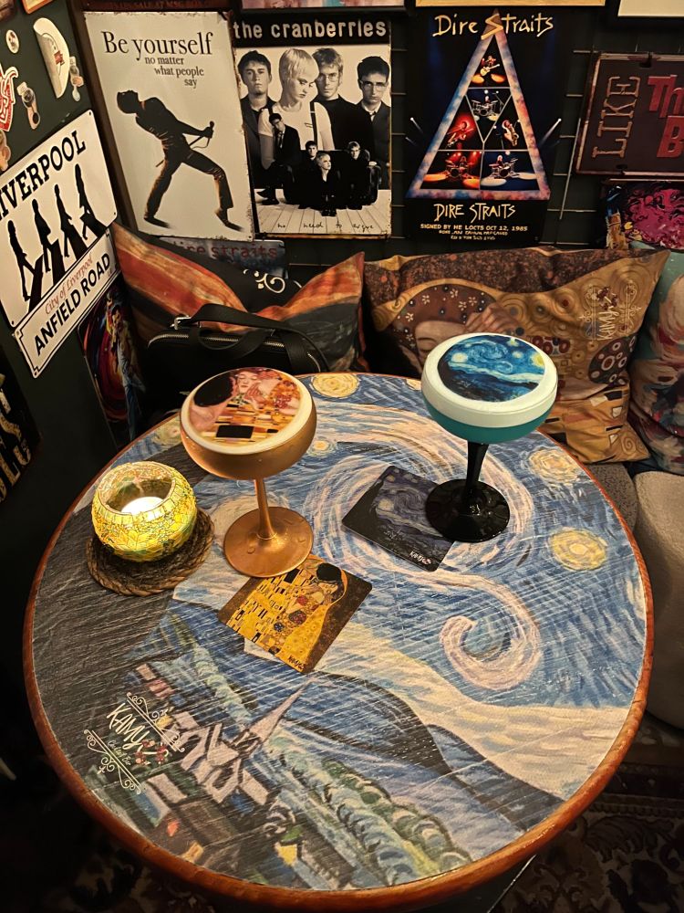 Cocktails with artwork decorated on top at Kamy